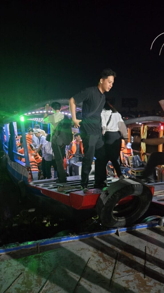 Guide shuffles people onto boat for morning ride