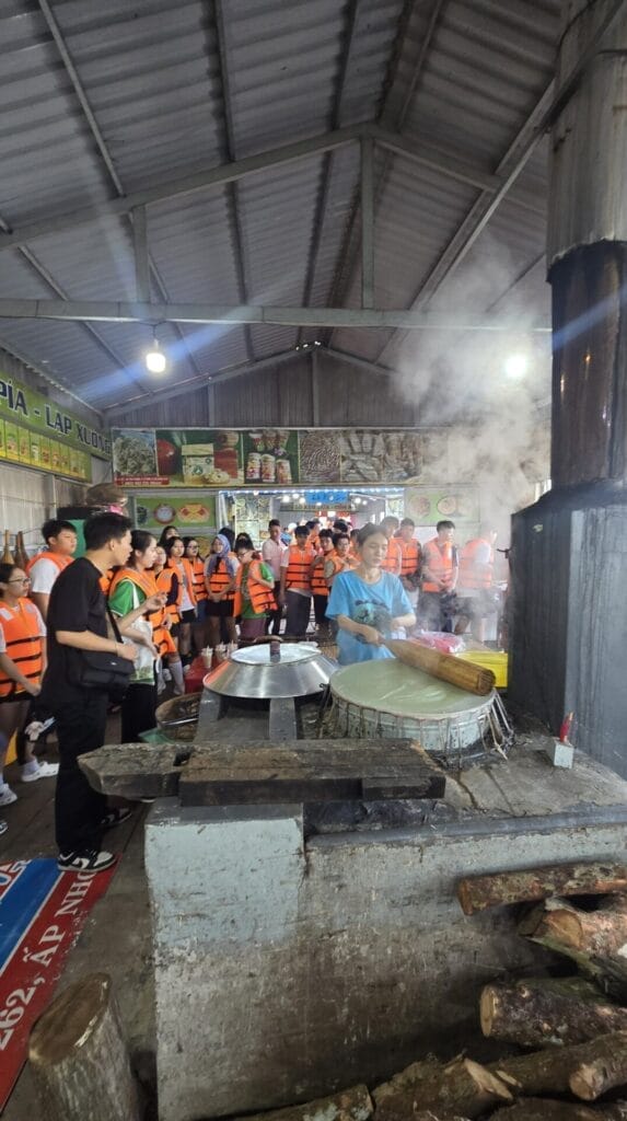 Craftsman demonstrate traditional cooking at Can Tho Floating market.